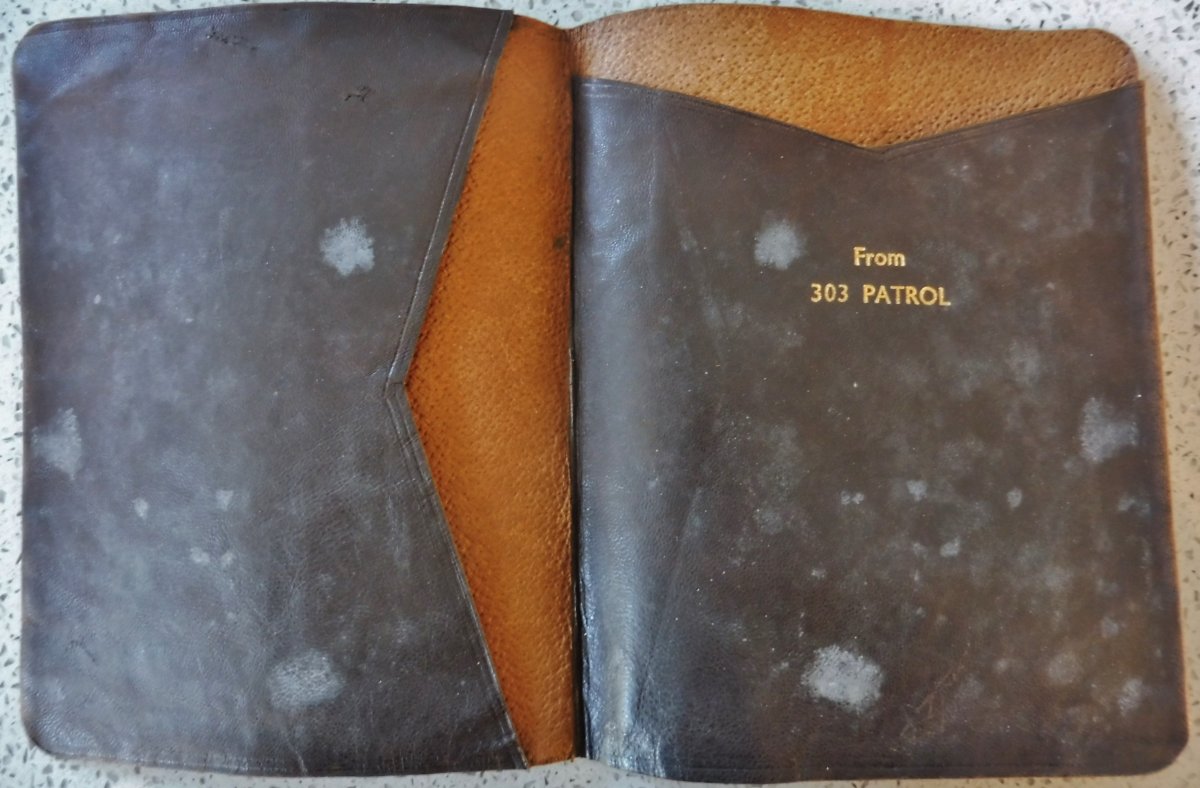 Brown leather folding wallet, opened to show inscription in gold "From 303 Patrol"